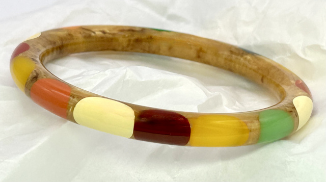 Shultz oatmeal tube bakelite bangle with 16 large wrap around polka dots in several colors