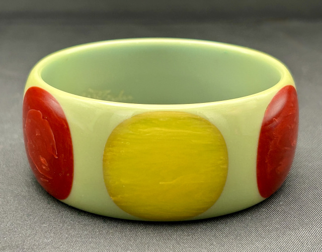 Jesse Fowler light sage green bakelite bangle with large marbled burgundy and lemon dots