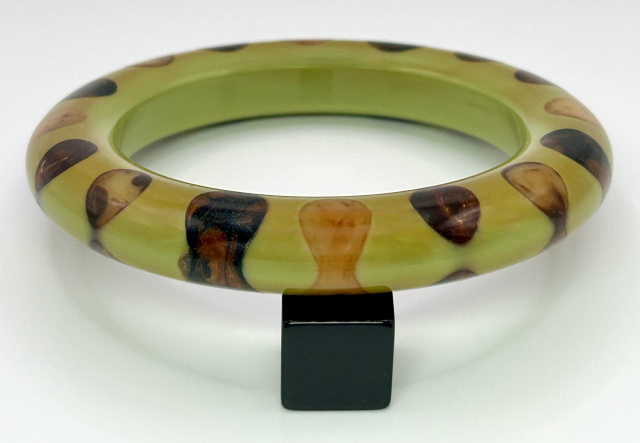 Atelier Papillon swamp green bakelite bangle with bowtie dots in marbled browns and butterscotch