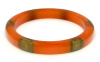 Atelier Papillon translucent orange bakelite bangle with six wrap around oatmel dots
