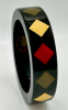 AB117 Lain near black bangle with diamond shaped inlays in red, ivory, palest olive