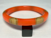 Atelier Papillon translucent orange bakelite bangle with six wrap around oatmel dots